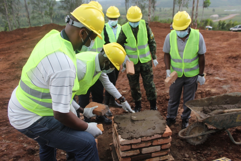 Officials laying a foundation stone at the construction of meat processing plant.