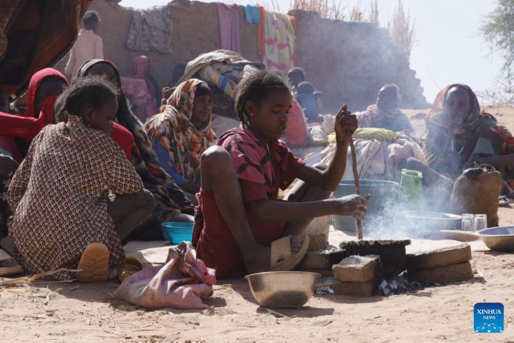 A girl prepares food at a displacement camp in El Fasher, North Darfur region, Sudan, on July 9, 2025. The United Nations Children's Fund (UNICEF) said Friday that the number of children suffering from severe acute malnutrition (SAM) in Sudan's North Darfur region has doubled as a result of the country's ongoing military conflict. (UNICEF/Handout via Xinhua)