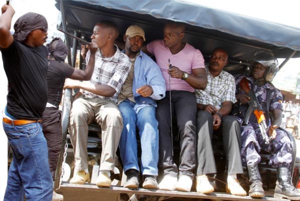Some of the stick wielding men: Bakali Mugumba Mutyaba (2nd Left), Moses Mayanja (holding stick) and Franco Ekea alias Kanyama