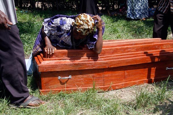 RIP. A woman weeps on the casket bearing remains of her relative outside Kasese Municipal Health Centre III mortuary yesterday.