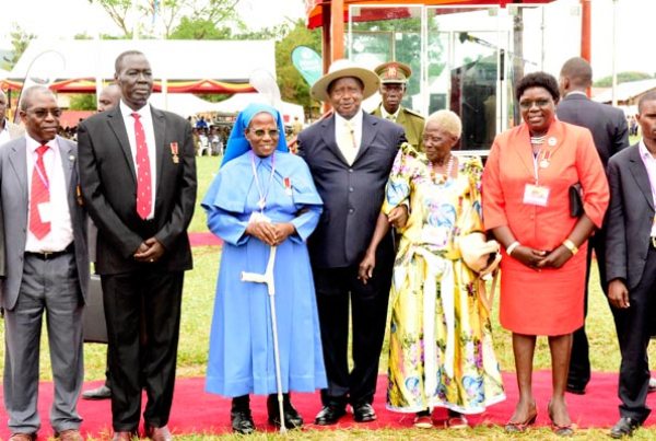 President Museveni with some of the medal winners during Labour Day celebrations at Duhaga Playgrounds, Hoima District, yesterday.
