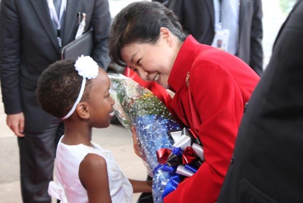 South Korean president, Park Geun-Hye, the receives a banquet of flowers from Megan Makanga at State House Entebbe yesterday.