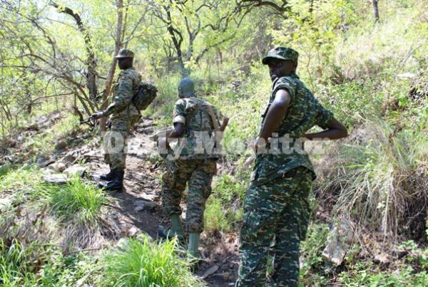 Maj Ronald Kakurungu (R), the UPDF spokesman for the 2nd Division, with other soldiers patrol the Semuliki valley in Rwamabale, Ntoroko District, on Wednesday.