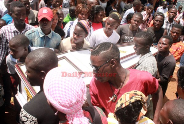 Friends bear the casket of Alex Ssempijja’s remains into his house in Makindye, Kampala, before it was transported to Mpigi for burial yesterday.
