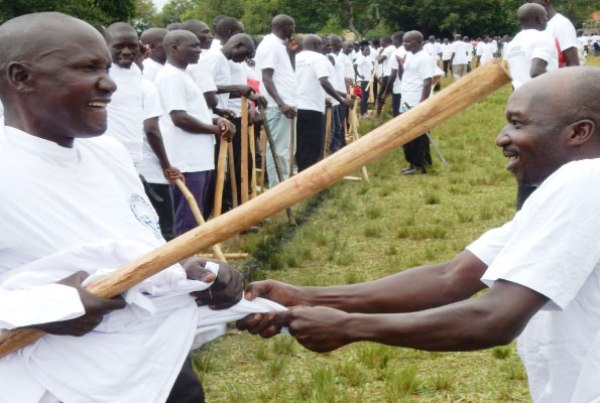 A crime preventer hassles a colleague over a free T- Shirt during a pass out in Lira town recently.