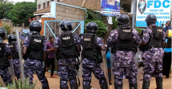Police officers surround the gate to the FDC party headquarters in Najjanankumbi, Kampala, yesterday after arresting the party’s deputy secretary general Harold Kaija whom they found addressing journalists. Mr Kaija said on May 12, former FDC presidential flag bearer Kizza Besigye will be sworn-in.