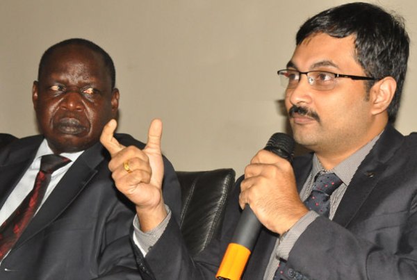 The Managing Director FATRO Consultant-Radiation Oncology, Dr M. Arunlal addresses the media in Kampala on Monday. Left is Fred Omach, the State Minister for Finance(General Duties).
