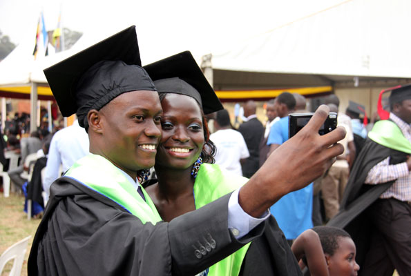 Graduands take a selfie during a previous graduation ceremony at Makerere University. The parents and graduands were charged Shs3,000 to keep phones