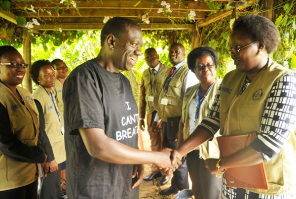 Dr Kizza Besigye (C) receives a team from the Uganda Human Rights Commission at his home in Kasangati, Wakiso District, yesterday.