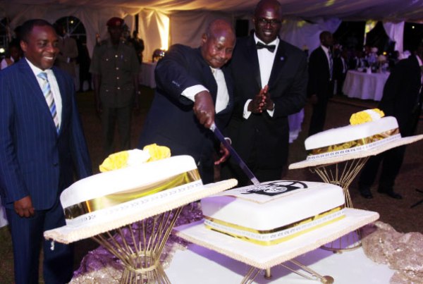 President Museveni cuts a cake during Uganda Law Society 60 years celebration in Kampala yesterday.