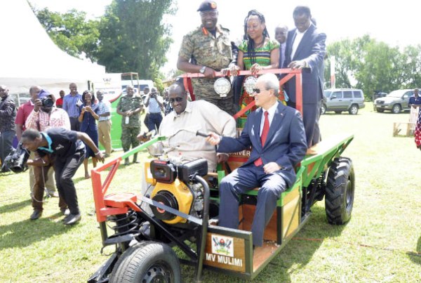 Gen Salim Saleh (seated left on the tractor), the chairman Operation Wealth Creation, and Chinese Ambassador to Uganda Zhao Yali (seated, right) and other officials aboard the MV Mulimi, during its launch on Thursday