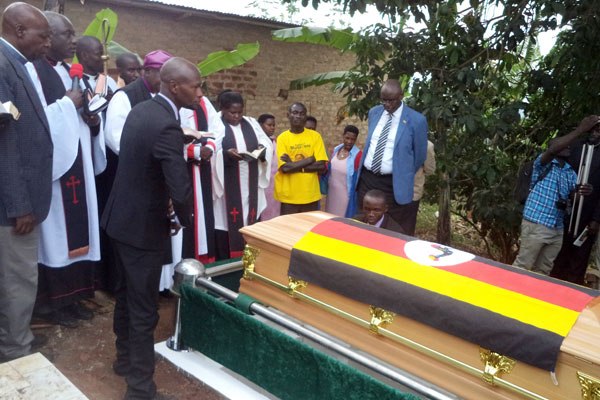 Njuneki’s casket is lowered into the grave during his burial in Mitooma District on Friday.