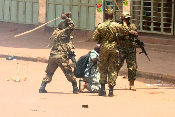 Brutality. An NTV video grab shows soldiers beating up Reuters photojournalist James Akena as he covered the protests over the detention of several Opposition MPs in Kampala on Monday. NTV PHOTO