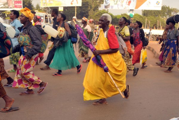 Eighty-year-old Rose Kiconco (with grey hair) with other pilgrims from Kasese Diocese walk past the Northern By-pass roundabout in Busega as they headed to Namugongo for Martyrs Day celebrations yesterday.
