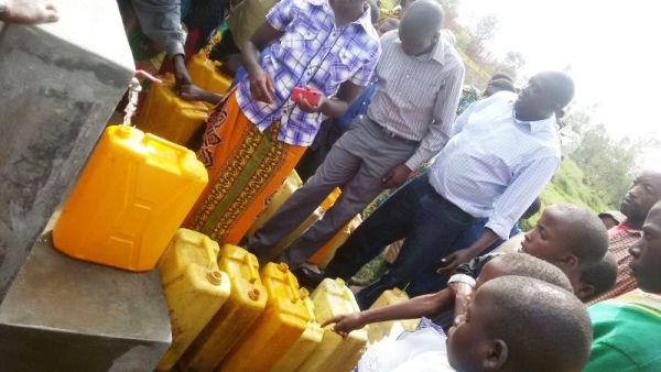 Residents fetching  during the inauguration of water supply