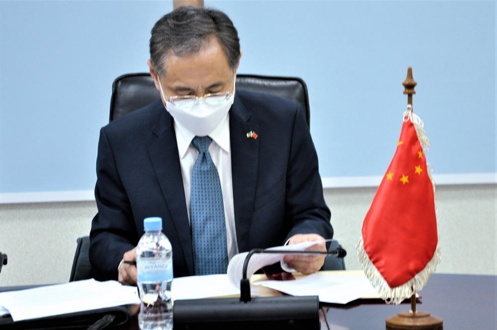 Chinese ambassador to Rwanda signing the agreement.  