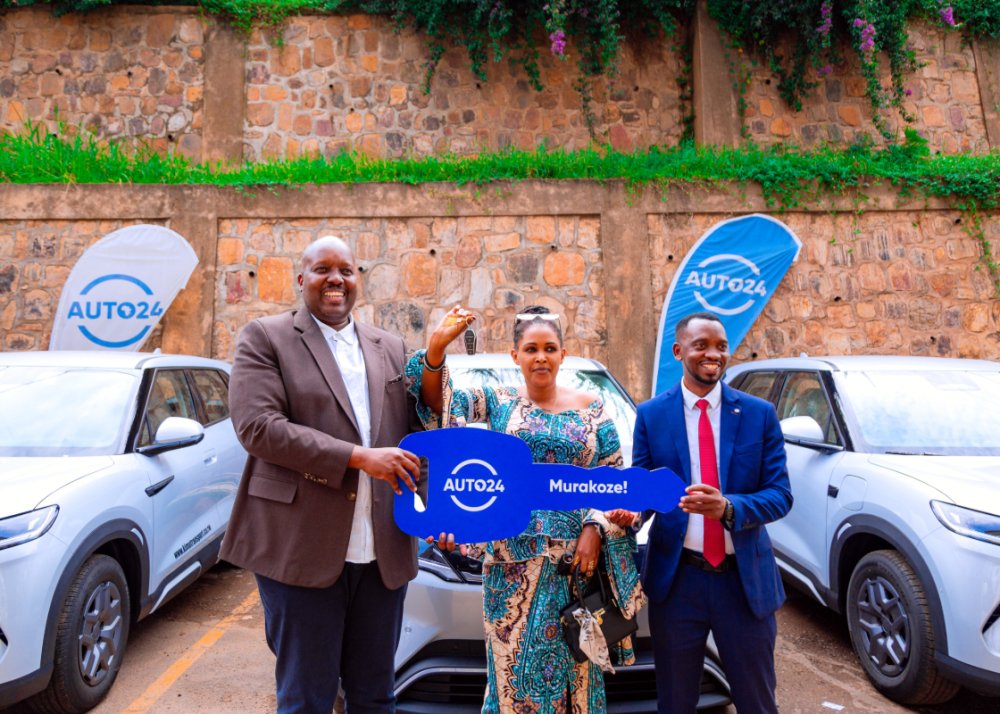 Auto24  Country Manager Ruzibiza Ivan, with the CEO of Kim Transport, Nkunziryayo Jean Pierre, and one of the company's drivers operating these vehicles.