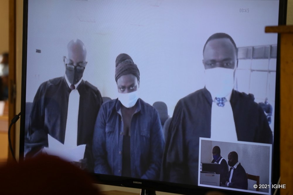 Idamange (in the middle) with her defense lawyers in court.