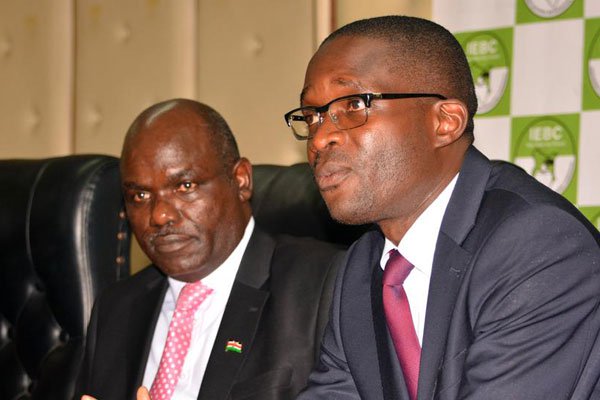 IEBC CEO Ezra Chiloba (right) and Chairman Wafula Chebukati. They have been advised to cancel the ballot tender if there is no agreement among political players.