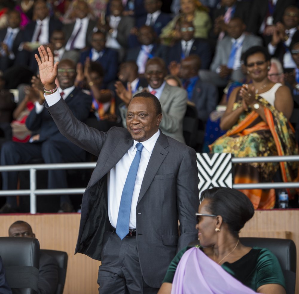 President Uhuru Kenyatta waving at the crowd gathered at the swearing-in ceremony of his Rwandan counterpart; President Kagame