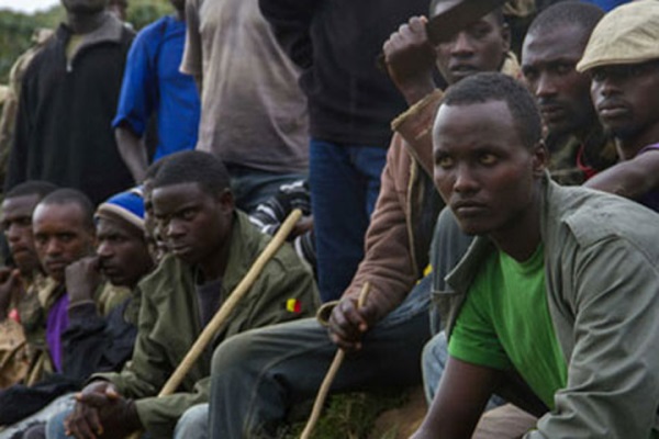 Members of the M23 rebel group sit at the Rwamwanja refugee settlement, Uganda on December 17, 2014.