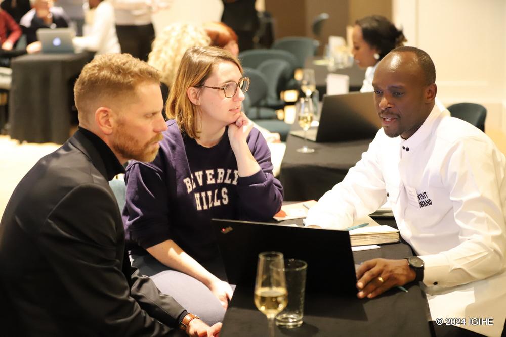 Hategekimana Lambert, representing Rwanda Eco Company and Safaris, engaging in discussions with interested individuals.