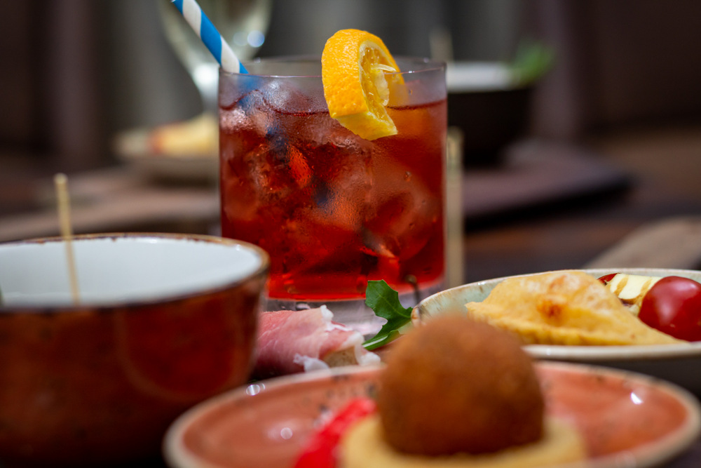 Aperitivo is derived from the Latin word, aperire, meaning opening. The pre-dinner drink and spread of food are meant to awaken the taste buds and stir up the stomach juices