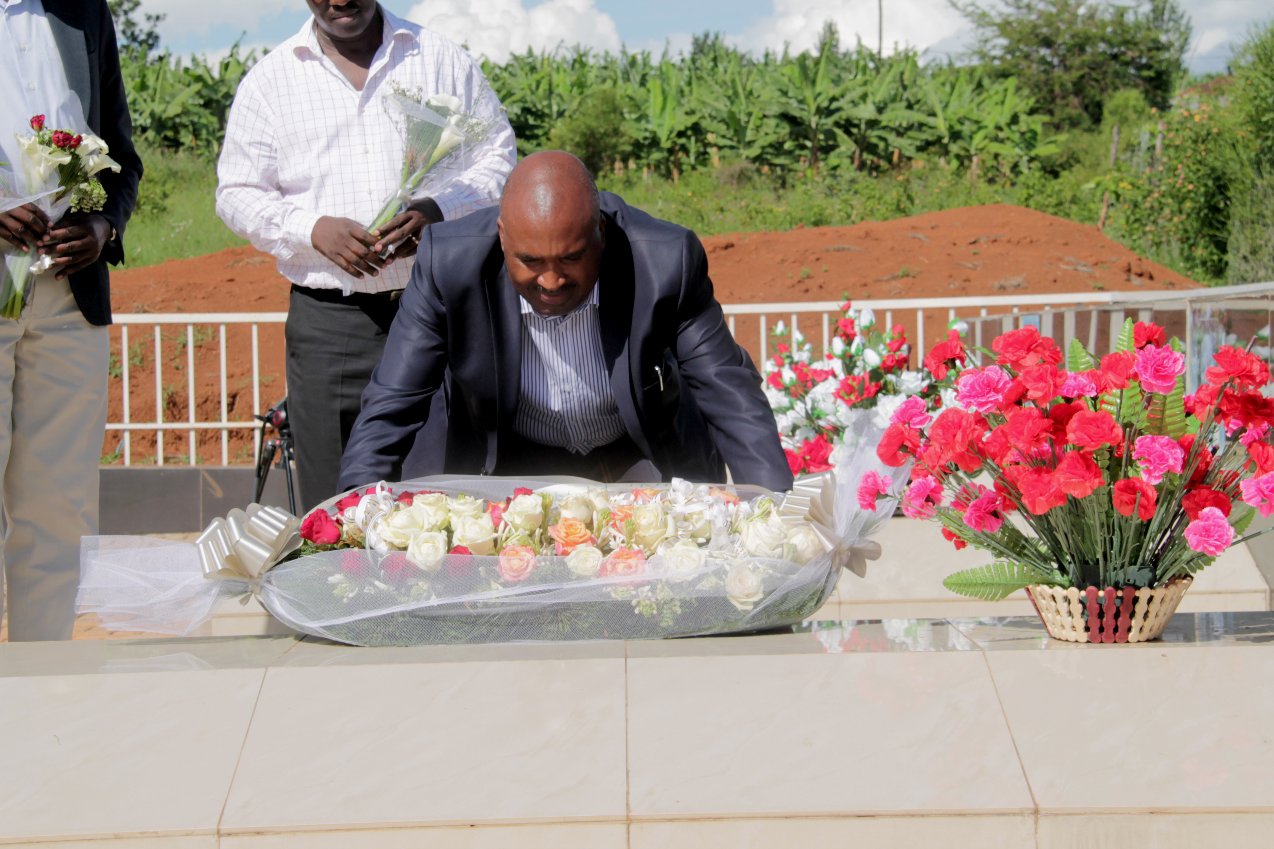 The Chairman Board of Directors, Mount Kenya University Rwanda Prof. Simon Gicharu laying a wreath at the grave of late Peter Clavers Nyombayire