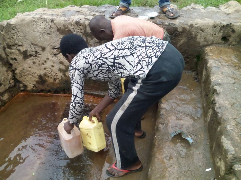 Residents fetching water in Mpenge river