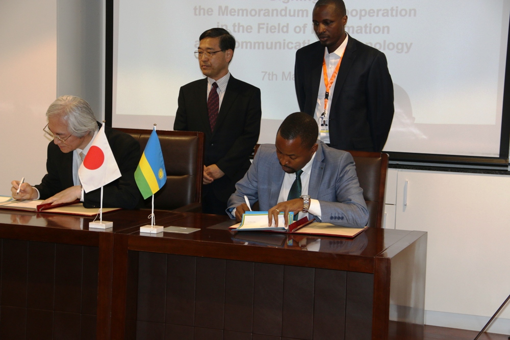 Minister Rurangirwa (R) and Japanese Vice-Minister of Internal Affairs and Communications, Masahiko Tominaga  signing the Memorandum of Cooperation.