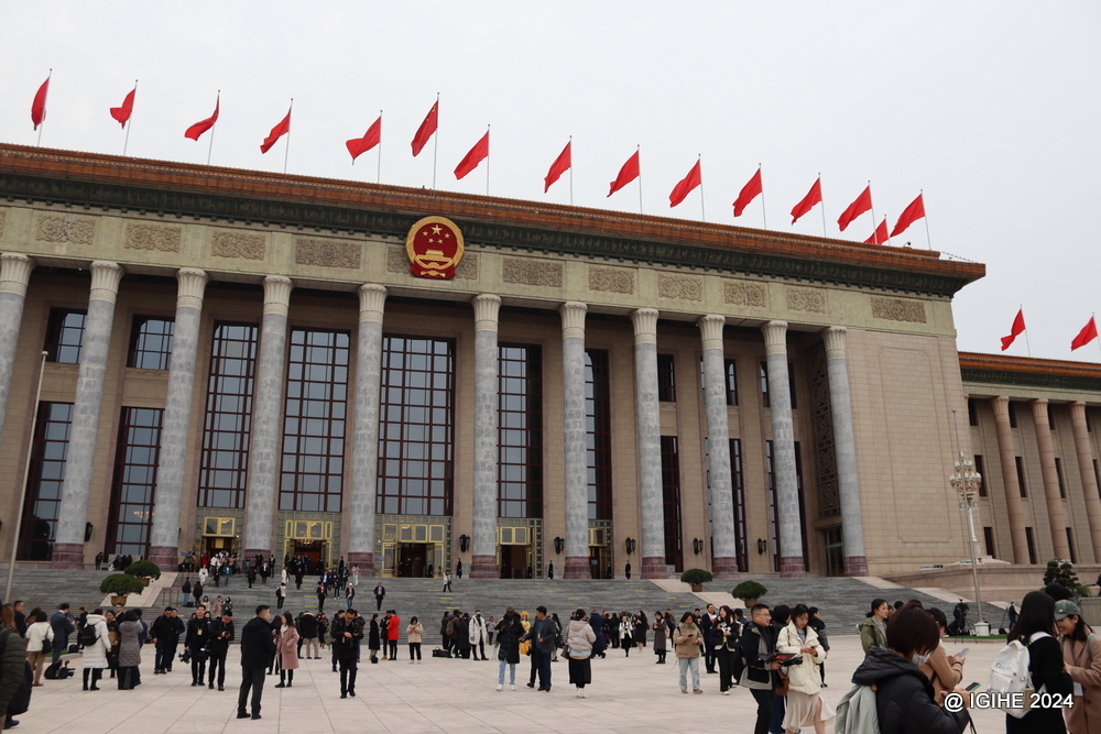 People walk outside the Great Hall of the People after attending the second session of the 14th CPPCC National Committee.