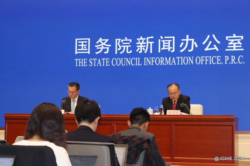 Mr. Huang Shouhong, head of the government work report drafting team and Director of the State Council Research Office (right) addressing members of the press after the opening session of CPC.  .