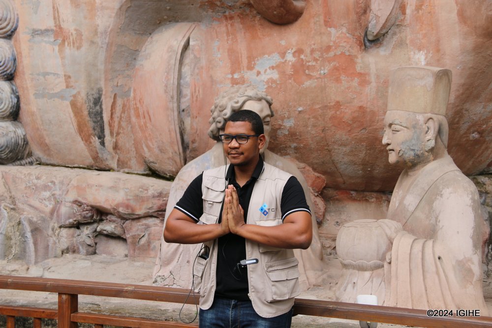 João Crisante de Pina, a journalist from Cape Verde posing for a photo at Dazu Rock Carvings.