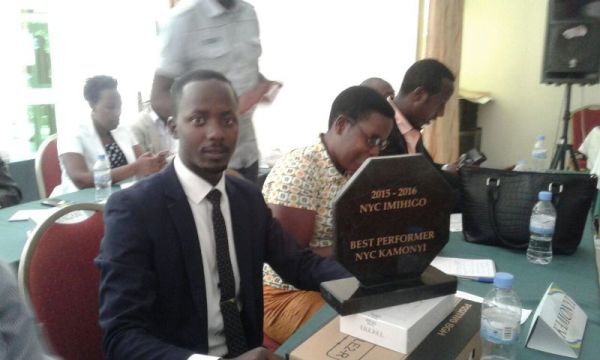 Kamanzi Ernest representing the youth in Kamonyi district holding the award