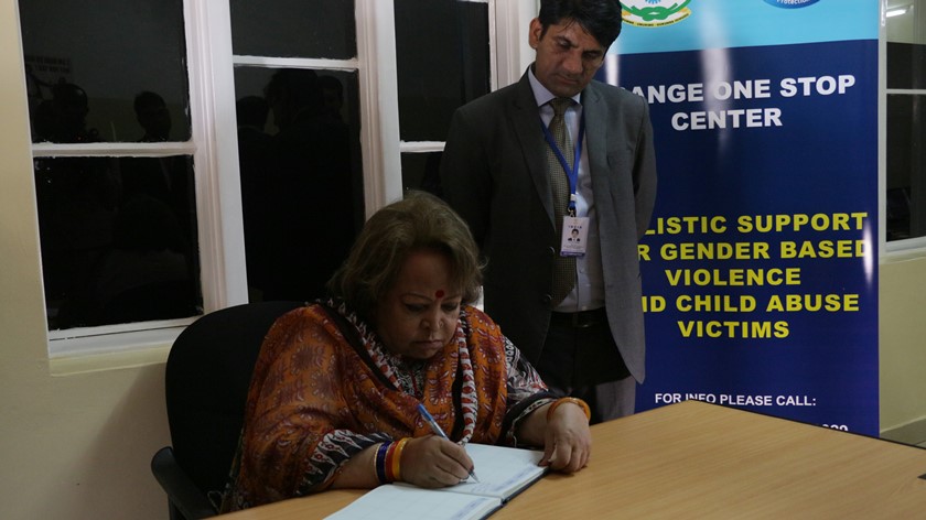 Mrs. Salma Ansari signs in the visiting book at Isange One Stop Center.