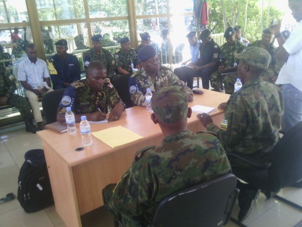 Rwandan soldiers and Congolese counterparts in discussions that preceded the handing over 2nd Lt Banango Bukware back to his home country  