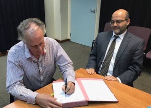 Inyenyeri's CEO, Reynolds signs as World Bank Group's El-Gammal looks on