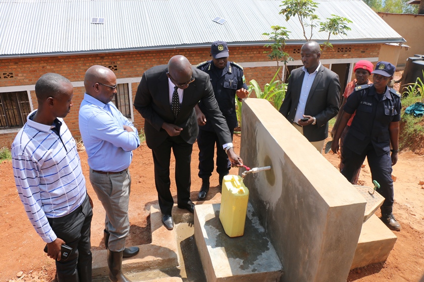 Minister Johnston flanked by IGP Emmanuel K. Gasana, Mayor of City of Kigali Pascal Nyamulinda and Mayor of Gasabo, inaugurating clean water sources in Jali.