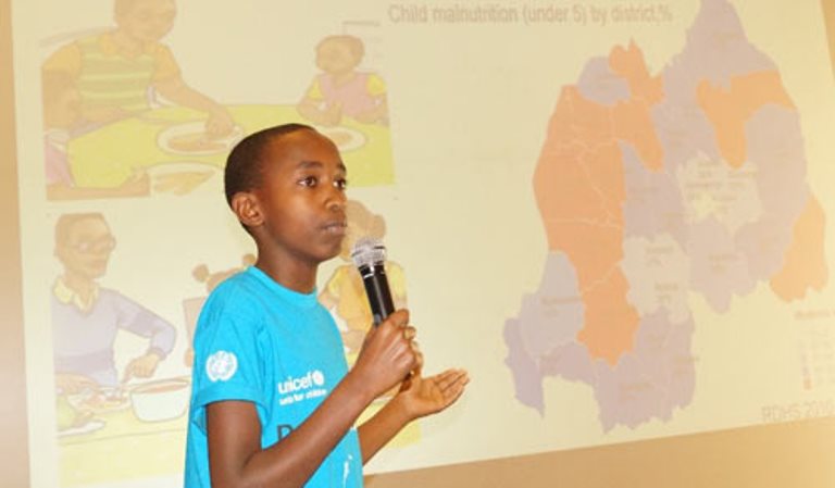 Josiah facilitates a discussion on malnutrition at the Reading Data with Children event.