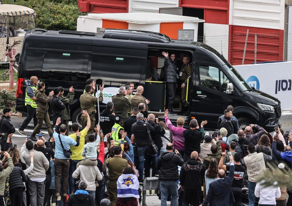 One of the freed Israeli hostage Tal Shoham waves to crowd as he arrives at a medical center in Petah Tikva, Israel, February 22, 2025.