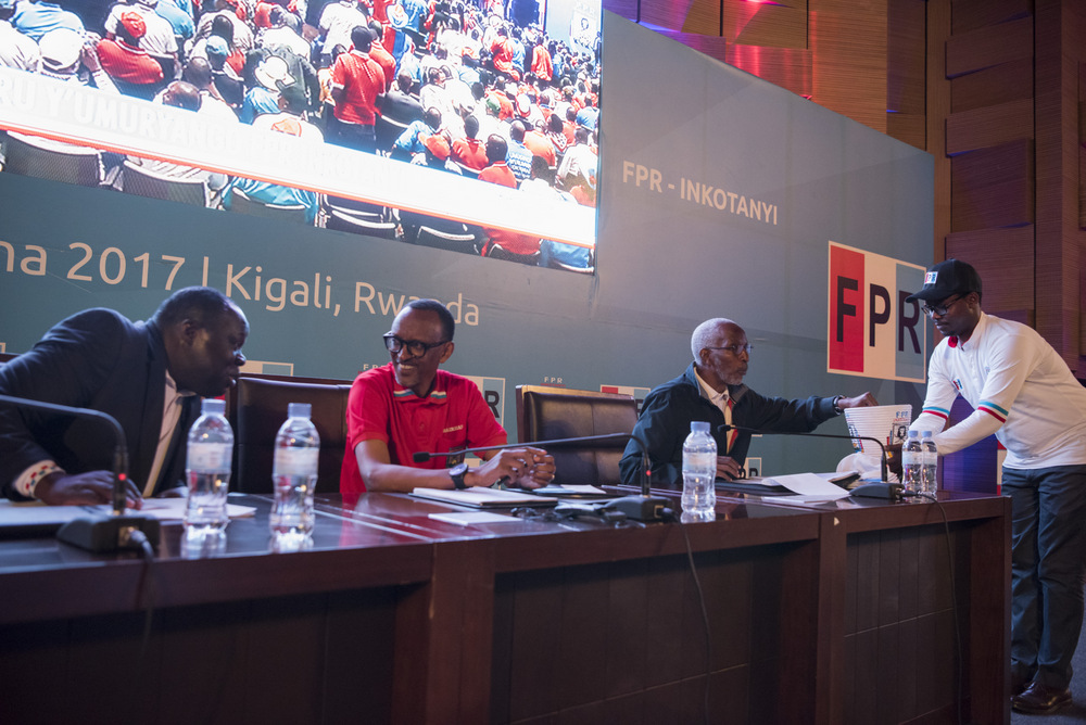 President Paul Kagame chats with vice president of RPF Inkotanyi, Bazivamo Christophe as the General secretary of RPF-Inkotanyi François Ngarambe cast the ballot