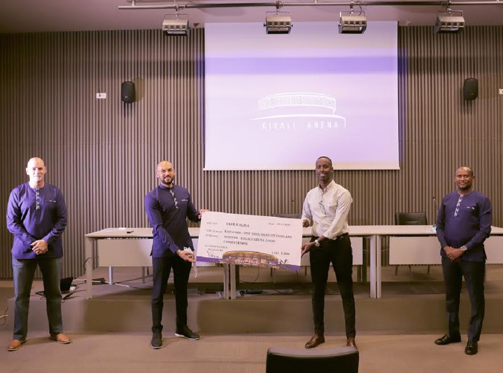 Axel Kalisa receiving a dummy cheque after winning the competition.  
