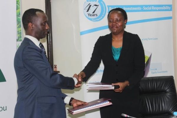 The CEO of BRD, Alex Kanyankore,and CEO of EADB Viviane Yeda exchange documents after signing agreements
