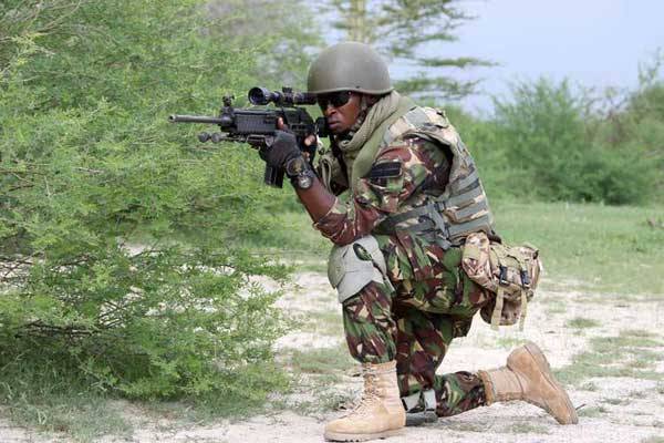 A Kenya Defence Forces soldier, hatted by the African Union Mission in Somalia (Amisom), takes aim while on patrol duty in Afmadow, Somalia, in November last year.