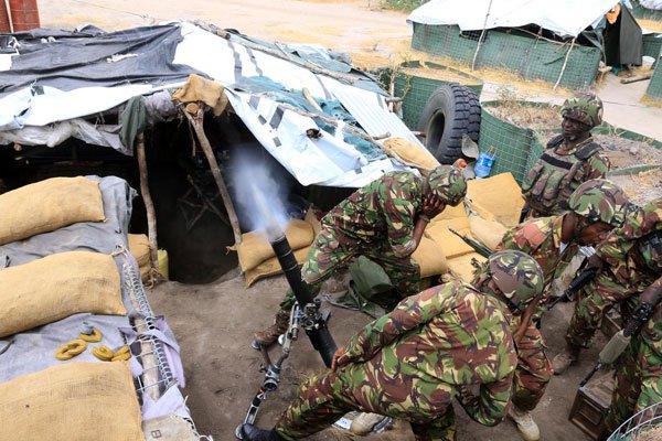 Kenya Defence Forces soldiers launch a propelled bomb inside their Kulbiyow camp in Somalia on February 6, 2017. The camp was attacked by Al-Shabaab militants two weeks ago.