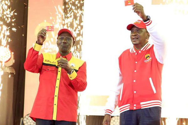 President Kenyatta (right) and his Deputy William Ruto display the Jubilee Party membership cards at Kasarani, Nairobi, on January 13, 2017. The cards have sold out.
