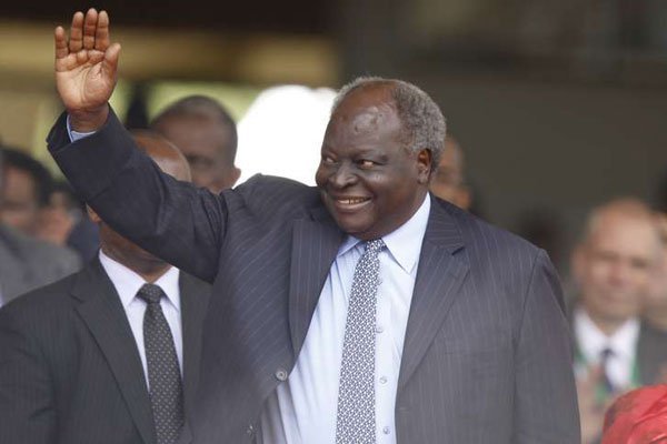 Former President Mwai Kibaki acknowledges greetings during the 50th Jamhuri Day celebration at Safaricom Stadium Kasarani in Nairobi on December 12, 2013.