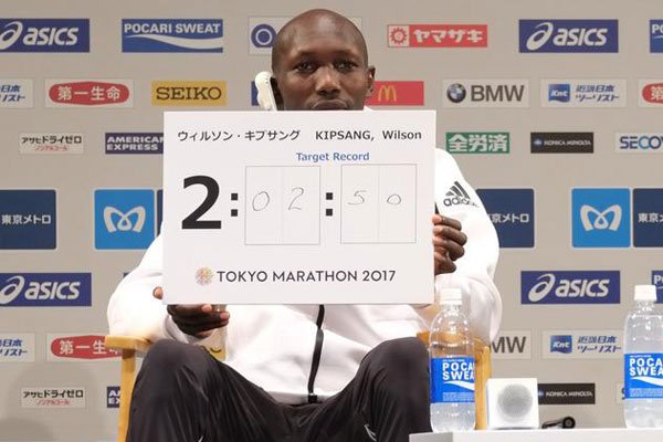 Kenya's Wilson Kipsang shows his target time of 2:02:50 during a press conference for this weekend's Tokyo marathon in Tokyo on February 24, 2017. Kipsang clocked 2hr 3min 58sec, winning the marathon.