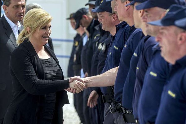 Croatia's President Kolinda Grabar Kitarovic (left) meets with Croatian and Slovenian police officers deployed at Greek-Macedonian border near Gevgelija, on April 13, 2016.