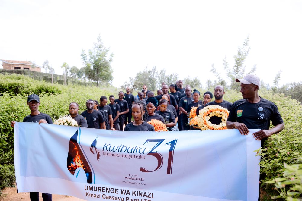 The employees approach Rutabo mass grave, where bodies of nearly 60,000 Tutsi were dumped.